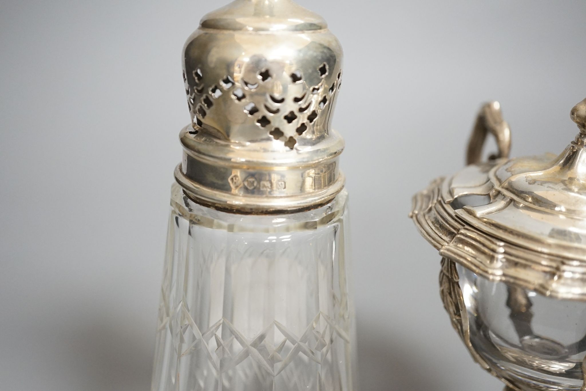 A George V silver mounted glass caster and a continental silver mustard pot frame (the latter a.f)